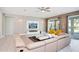 Spacious living room with sectional sofa, coffee table, and large TV at 7736 Graben St, Kissimmee, FL 34747