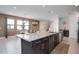 Open concept kitchen with granite island and stainless steel appliances at 7736 Graben St, Kissimmee, FL 34747