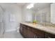 Double vanity bathroom with granite countertop and shower at 7736 Graben St, Kissimmee, FL 34747