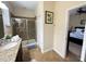 Bathroom with walk-in shower and view of bedroom at 9030 Shadow Mountain St, Davenport, FL 33896