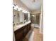 Elegant bathroom with double vanity, granite countertops, and a large walk-in shower at 9030 Shadow Mountain St, Davenport, FL 33896