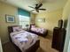 Bedroom with two twin beds, TV, and ample closet space at 9030 Shadow Mountain St, Davenport, FL 33896