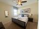 King-size bed and ensuite bathroom in a well-lit bedroom at 9030 Shadow Mountain St, Davenport, FL 33896