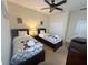 Two twin beds with Mickey Mouse bedding and ceiling fan at 9030 Shadow Mountain St, Davenport, FL 33896