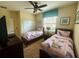Two twin beds with unicorn bedding in a well-lit bedroom at 9030 Shadow Mountain St, Davenport, FL 33896