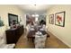 Open concept dining room with a large table and view into the kitchen and living room at 9030 Shadow Mountain St, Davenport, FL 33896