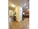 Long hallway with tile floors and access to bedrooms and kitchen at 9030 Shadow Mountain St, Davenport, FL 33896
