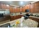 Spacious kitchen with granite countertops and stainless steel appliances at 9030 Shadow Mountain St, Davenport, FL 33896