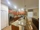 Open kitchen with granite countertops and stainless steel appliances at 9030 Shadow Mountain St, Davenport, FL 33896