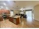 Open concept kitchen with island, stainless steel appliances, and view to living room at 9030 Shadow Mountain St, Davenport, FL 33896
