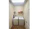 Laundry room with washer, dryer, and overhead shelving at 9030 Shadow Mountain St, Davenport, FL 33896