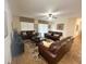 Spacious living room with dark leather sofas and tile floors at 9030 Shadow Mountain St, Davenport, FL 33896