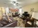 Spacious living room with leather sofas, a coffee table, and a large TV at 9030 Shadow Mountain St, Davenport, FL 33896