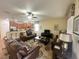 Bright living room featuring a comfortable seating area and access to the kitchen at 9030 Shadow Mountain St, Davenport, FL 33896