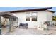 Fenced backyard, with a patio, dog kennel, and storage bench at 9195 Chandler Dr, Groveland, FL 34736