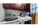 Laundry room with Samsung washer and dryer, plus ample cabinet space at 9195 Chandler Dr, Groveland, FL 34736