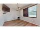 Bright dining area with barn door and wood-look floors at 9195 Chandler Dr, Groveland, FL 34736