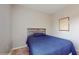 Small bedroom with a full-size bed and neutral walls at 9195 Chandler Dr, Groveland, FL 34736