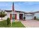 One-story home with red shutters, stone accents, and a two-car garage at 9195 Chandler Dr, Groveland, FL 34736