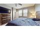 Main bedroom with large bed, dresser, and TV at 9195 Chandler Dr, Groveland, FL 34736