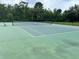 Two well-maintained tennis courts with benches, ready for recreation at 10065 Lake District Ln, Orlando, FL 32832