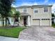 Beautiful two-story home with a large driveway and inviting porch at 10065 Lake District Ln, Orlando, FL 32832