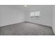 Spacious bedroom with grey carpet and large window at 246 Mandovi St, Davenport, FL 33837