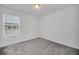 Bright bedroom with grey carpet and window with blinds at 246 Mandovi St, Davenport, FL 33837