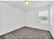 Bright bedroom with grey carpet and window with blinds at 246 Mandovi St, Davenport, FL 33837