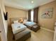 Bedroom with two twin beds, artwork, and natural light at 3131 Brasilia Ave, Kissimmee, FL 34747
