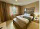 Main bedroom with king-size bed and large window at 3131 Brasilia Ave, Kissimmee, FL 34747