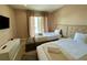 Bedroom with two twin beds, TV, and access to balcony at 3131 Brasilia Ave, Kissimmee, FL 34747