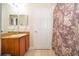 Bathroom with granite vanity, shower, and patterned shower curtain at 3520 Calabria Ave # 3520, Davenport, FL 33897