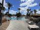 Community pool with lounge chairs and palm trees on a sunny day at 3520 Calabria Ave # 3520, Davenport, FL 33897