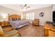 King sized bed, two nightstands, and a sitting chair in the main bedroom at 3520 Calabria Ave # 3520, Davenport, FL 33897