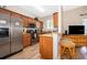 Modern kitchen with stainless steel appliances and wooden cabinetry at 3520 Calabria Ave # 3520, Davenport, FL 33897