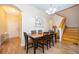 Bright dining room featuring a wooden table and six chairs, adjacent to the entryway at 3520 Calabria Ave # 3520, Davenport, FL 33897