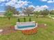 Community entrance sign with landscaping and a water feature at 5135 Tana Ter, Saint Cloud, FL 34773