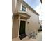 Exterior view of a townhouse entrance with a dark green door at 6462 Cantua Ln # 105, Orlando, FL 32835