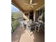 Screened balcony with patio furniture, ceiling fan and dartboard at 6462 Cantua Ln # 105, Orlando, FL 32835