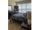 Spacious bedroom with large windows, dresser and a king-size bed at 6462 Cantua Ln # 105, Orlando, FL 32835