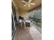 Screened balcony with patio furniture, ceiling fan and view of trees at 6462 Cantua Ln # 105, Orlando, FL 32835
