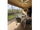 Screened balcony with patio furniture, ceiling fan and view of trees at 6462 Cantua Ln # 105, Orlando, FL 32835