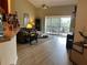 Bright living room with access to balcony and hardwood floors at 6462 Cantua Ln # 105, Orlando, FL 32835