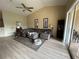 Living room with gray sectional sofa and light flooring at 6462 Cantua Ln # 105, Orlando, FL 32835