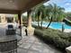 Community patio with pool view and seating at 6462 Cantua Ln # 105, Orlando, FL 32835