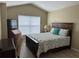 Main bedroom with king-size bed and a writing desk at 6462 Cantua Ln # 105, Orlando, FL 32835