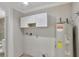 Laundry room with white cabinets and A.O. Smith water heater at 1053 E Hancock Dr, Deltona, FL 32725