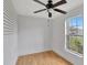 Bedroom with wood-look floors, a window, and a ceiling fan at 1053 E Hancock Dr, Deltona, FL 32725