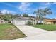 House exterior featuring a garage and landscaping at 1053 E Hancock Dr, Deltona, FL 32725